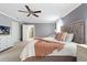 Bedroom showcasing a luxurious bed, ceiling fan, and a nearby dresser with a television at 14664 Spotted Sandpiper Blvd, Winter Garden, FL 34787