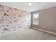 Bedroom with accent floral wall and carpet flooring at 14664 Spotted Sandpiper Blvd, Winter Garden, FL 34787