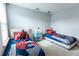 bedroom features two beds with Spider-Personal bedding and a colorful accent table at 14664 Spotted Sandpiper Blvd, Winter Garden, FL 34787