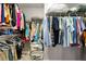 Organized walk-in closet with ample hanging space and shelving for clothing and accessories at 14664 Spotted Sandpiper Blvd, Winter Garden, FL 34787