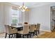 Dining area featuring modern lighting fixture, dining table and six chairs at 14664 Spotted Sandpiper Blvd, Winter Garden, FL 34787