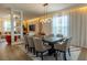 Stylish dining room with a modern chandelier, large table, and decorative wall accents at 14664 Spotted Sandpiper Blvd, Winter Garden, FL 34787