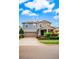 Stately two-story home with solar panels, a paved driveway, and nicely landscaped front yard at 14664 Spotted Sandpiper Blvd, Winter Garden, FL 34787