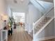Bright foyer with wood floors, staircase, and view into the living room, creating an inviting entrance at 14664 Spotted Sandpiper Blvd, Winter Garden, FL 34787