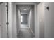 Clean hallway with neutral paint and carpet, featuring several doorways and a modern thermostat at 14664 Spotted Sandpiper Blvd, Winter Garden, FL 34787