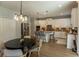 Bright kitchen featuring an island, granite countertops, stainless appliances and a modern chandelier at 14664 Spotted Sandpiper Blvd, Winter Garden, FL 34787
