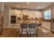 Spacious kitchen island with stainless steel appliances, granite countertops and white cabinetry at 14664 Spotted Sandpiper Blvd, Winter Garden, FL 34787