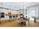 Bright and airy kitchen with white cabinetry, an island with seating, and modern appliances at 14664 Spotted Sandpiper Blvd, Winter Garden, FL 34787