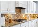 Bright kitchen with granite countertops, stainless steel appliances, and decorative tile backsplash at 14664 Spotted Sandpiper Blvd, Winter Garden, FL 34787