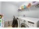 Laundry room with a washer and dryer set, wire shelving and convenient storage solutions at 14664 Spotted Sandpiper Blvd, Winter Garden, FL 34787