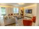 Elegant living room featuring textured walls, modern furniture, and ample natural light at 14664 Spotted Sandpiper Blvd, Winter Garden, FL 34787