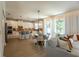 Open floor plan featuring a cozy living room next to an eat-in kitchen with modern countertops at 14664 Spotted Sandpiper Blvd, Winter Garden, FL 34787