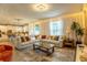 Open living room with recessed lighting and windows flowing into the kitchen with an eat-in island at 14664 Spotted Sandpiper Blvd, Winter Garden, FL 34787