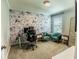 Bright office with floral wallpaper accent wall, plush seating, and a comfortable workspace at 14664 Spotted Sandpiper Blvd, Winter Garden, FL 34787
