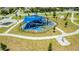 Playground with a blue sunshade, playground equipment, and walking paths for outdoor fun at 14664 Spotted Sandpiper Blvd, Winter Garden, FL 34787