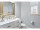 Bright powder room with marble countertop, stylish faucet, and modern fixtures at 14664 Spotted Sandpiper Blvd, Winter Garden, FL 34787