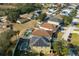 An aerial view of a neighborhood showcasing various homes with some featuring pools and solar panels at 1602 Pine Ridge Dr, Davenport, FL 33896