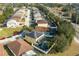 An aerial shot of a house with solar panels, pool, and fenced yard in a vibrant neighborhood at 1602 Pine Ridge Dr, Davenport, FL 33896