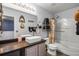 Well-lit bathroom with modern sink, toilet, and shower with a white door at 1602 Pine Ridge Dr, Davenport, FL 33896