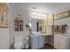 Charming bathroom with decorative wall art, a vessel sink, and ample lighting for a relaxing atmosphere at 1602 Pine Ridge Dr, Davenport, FL 33896