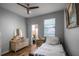 Serene bedroom with a vintage dresser, soft lighting, and a comfortable bed at 1602 Pine Ridge Dr, Davenport, FL 33896