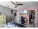 Bedroom with pink walls, ceiling fan, television and walk-in closet at 1602 Pine Ridge Dr, Davenport, FL 33896