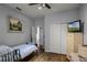 Well-lit bedroom with a simple design, hardwood floors, and neutral colors at 1602 Pine Ridge Dr, Davenport, FL 33896