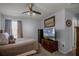 Comfortable bedroom with a ceiling fan and a dresser with a television at 1602 Pine Ridge Dr, Davenport, FL 33896