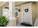 Welcoming front porch with a decorative wreath, 'Welcome to our Porch' sign, and inviting decor at 1602 Pine Ridge Dr, Davenport, FL 33896