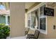 Charming front porch with a 'Welcome to our Porch' sign, chairs, and view of neighborhood at 1602 Pine Ridge Dr, Davenport, FL 33896