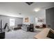 Relaxing living room with comfortable gray sectional, large window, and open doorway to the bedroom at 1602 Pine Ridge Dr, Davenport, FL 33896