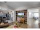 Open-concept living room features a wood accent wall and flows into the adjacent kitchen at 1602 Pine Ridge Dr, Davenport, FL 33896