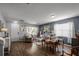 Cozy living room and dining room with wood floors, natural light, and stylish furnishings at 1602 Pine Ridge Dr, Davenport, FL 33896