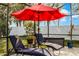 Relaxing patio with lounge chairs and a shade umbrella at 1602 Pine Ridge Dr, Davenport, FL 33896