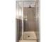 Modern walk-in shower featuring glass doors, sleek tile, and a high-quality shower head and fixtures at 1602 Pine Ridge Dr, Davenport, FL 33896