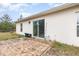 A backyard patio made of brick pavers outside of sliding glass doors to the home at 195 Maple Dr, Kissimmee, FL 34759