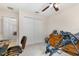 Bedroom featuring a ceiling fan, closet and home office setup at 195 Maple Dr, Kissimmee, FL 34759