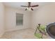 Bedroom features a ceiling fan, window and fitness equipment at 195 Maple Dr, Kissimmee, FL 34759