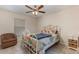 Bedroom boasts a ceiling fan, window, and white metal bed frame at 195 Maple Dr, Kissimmee, FL 34759