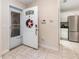 Welcoming foyer with tile flooring leading to a modern kitchen at 195 Maple Dr, Kissimmee, FL 34759