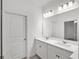 Bathroom featuring double sinks and white cabinets at 1988 Sunshine Peak Dr, Minneola, FL 34715