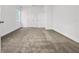 An empty bedroom features two doors and neutral carpeting at 1988 Sunshine Peak Dr, Minneola, FL 34715