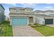 Charming two-story home featuring a blue garage door, stone accents, and a brick paver driveway at 1988 Sunshine Peak Dr, Minneola, FL 34715