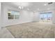 Large living room with neutral carpet, a chandelier, and a view of the backyard at 1988 Sunshine Peak Dr, Minneola, FL 34715