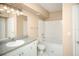 Bathroom with a tub, sink, and a mirror with updated fixtures at 206 E South St # 4031, Orlando, FL 32801