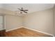 Bedroom with a ceiling fan, hardwood floors, and neutral-colored walls at 206 E South St # 4031, Orlando, FL 32801