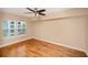 Bright bedroom with hardwood floors, a ceiling fan, and a sun-drenched window at 206 E South St # 4031, Orlando, FL 32801