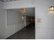 Long view of hallway with exit sign, wall paneling, and light fixtures at 206 E South St # 4031, Orlando, FL 32801