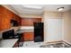 Bright kitchen with modern cabinets, electric range, and black refrigerator at 206 E South St # 4031, Orlando, FL 32801