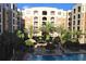 Resort-style pool area with palm trees and lush landscaping at a luxury condominium complex at 206 E South St # 4031, Orlando, FL 32801